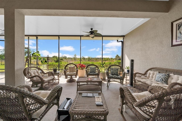 sunroom / solarium featuring ceiling fan