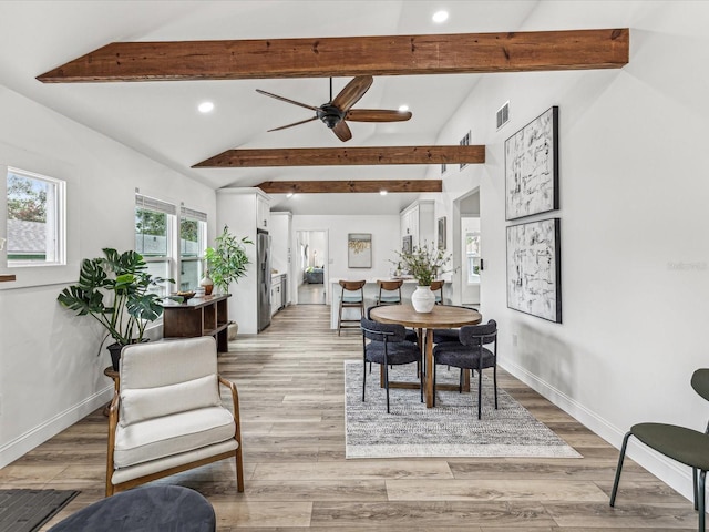 dining room featuring light hardwood / wood-style flooring, lofted ceiling with beams, and ceiling fan