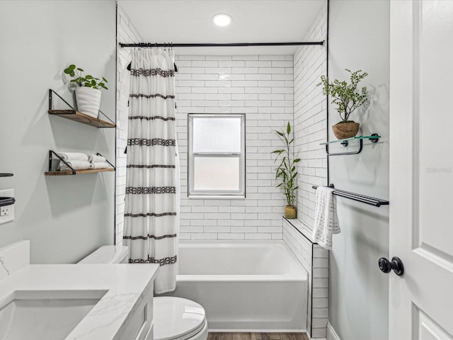 full bathroom featuring vanity, shower / bath combination with curtain, and toilet