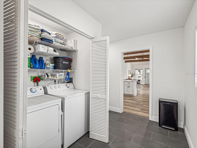 washroom featuring dark tile patterned flooring and washing machine and dryer