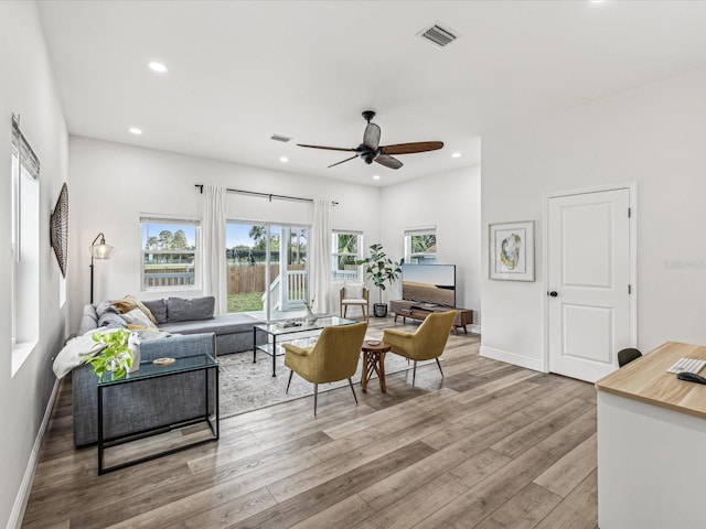 living room featuring light hardwood / wood-style flooring and ceiling fan