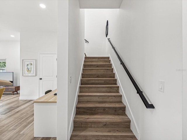 staircase with wood-type flooring