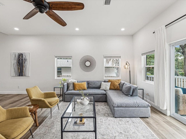 living room with ceiling fan and light hardwood / wood-style floors