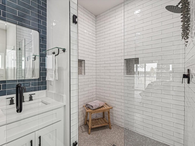 bathroom with vanity and a tile shower