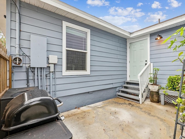 property entrance with a patio area