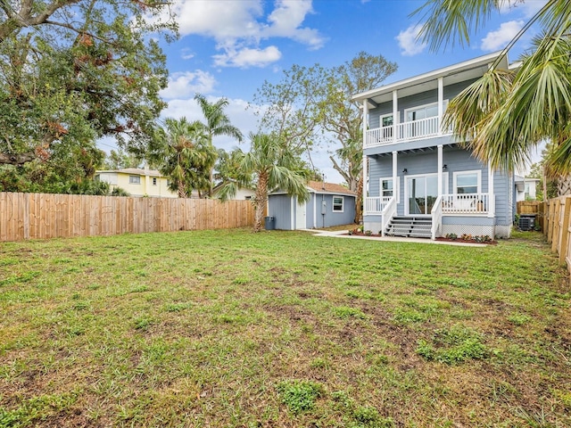 view of yard with a balcony and a storage unit