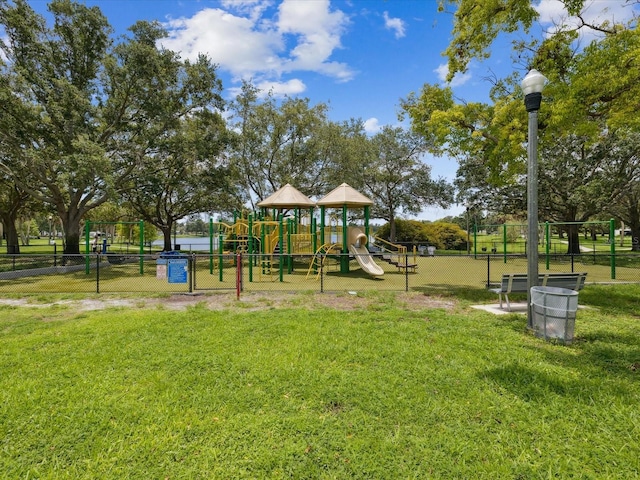 view of jungle gym featuring a lawn