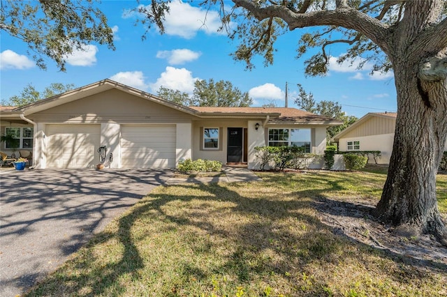 ranch-style home featuring a garage and a front yard