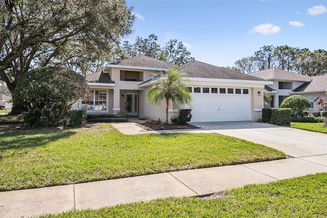 view of front of house with a front yard and a garage