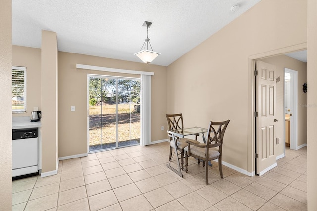 dining space featuring light tile patterned floors, a wealth of natural light, and lofted ceiling