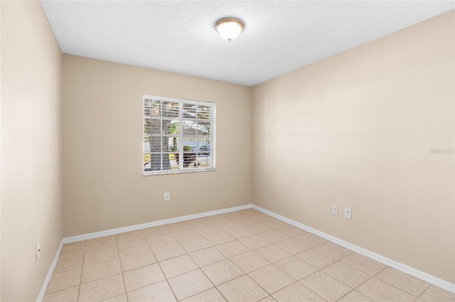 unfurnished room with a textured ceiling