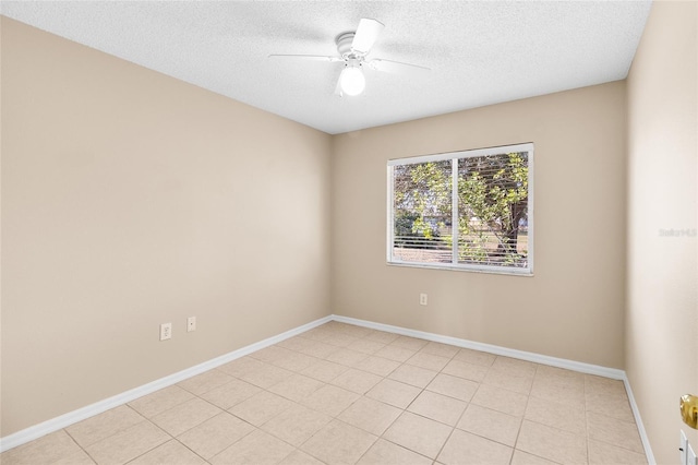 unfurnished room with ceiling fan and a textured ceiling