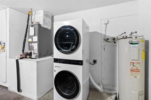 laundry room with heating unit, water heater, a textured ceiling, and stacked washing maching and dryer