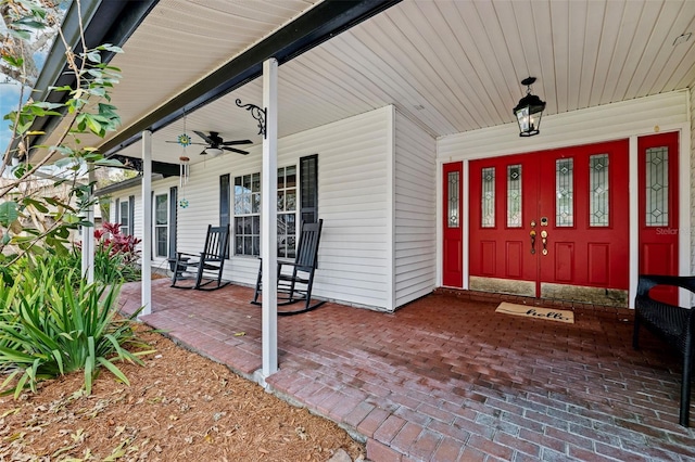 doorway to property with ceiling fan and covered porch