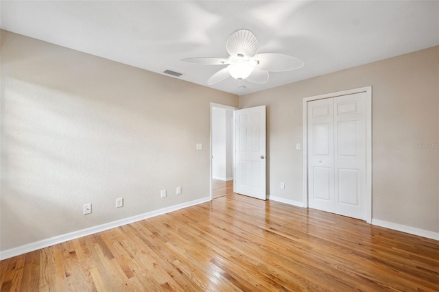 unfurnished bedroom with a closet, ceiling fan, and light hardwood / wood-style flooring