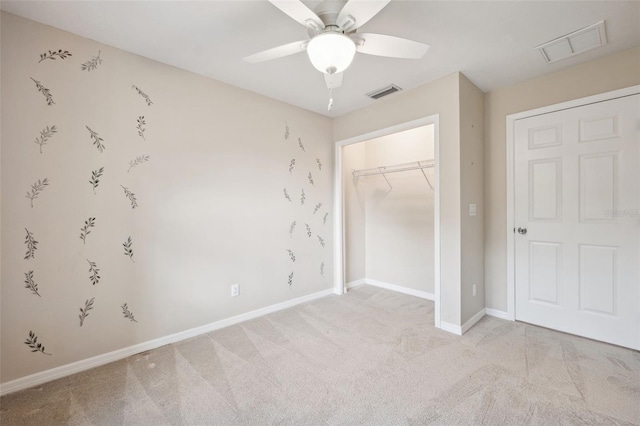 unfurnished bedroom with ceiling fan, light colored carpet, and a closet