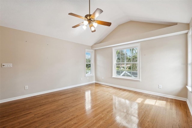 empty room featuring vaulted ceiling, light hardwood / wood-style floors, and ceiling fan