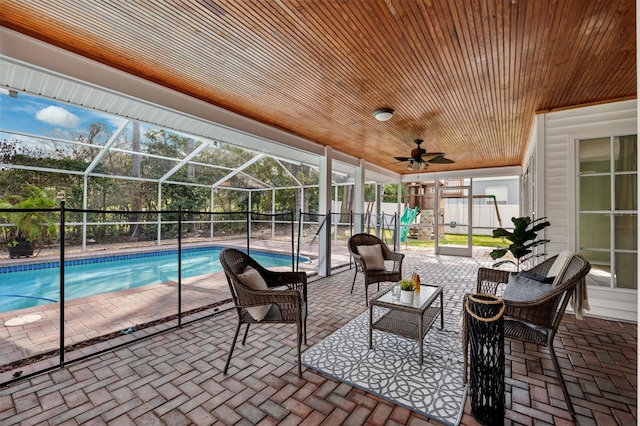 view of patio featuring a playground, a fenced in pool, and glass enclosure