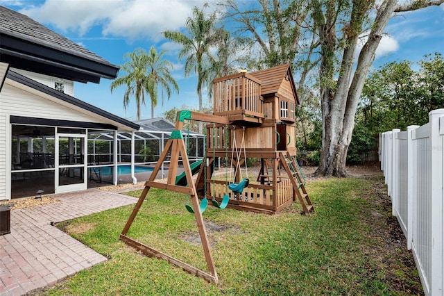 view of play area with a patio, a lanai, and a lawn