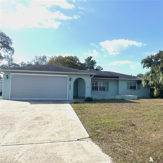 ranch-style home with a garage and a front yard