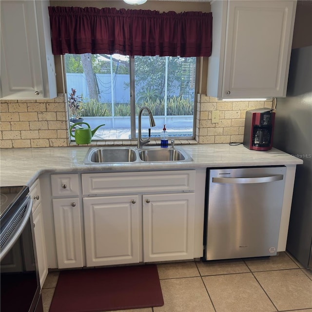 kitchen with white cabinetry, dishwasher, sink, and range with electric cooktop