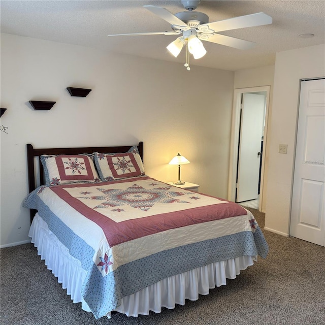 bedroom with ceiling fan, a textured ceiling, and dark colored carpet