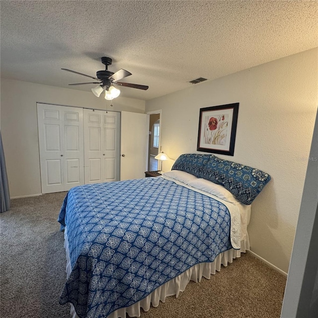 carpeted bedroom with a textured ceiling, a closet, and ceiling fan