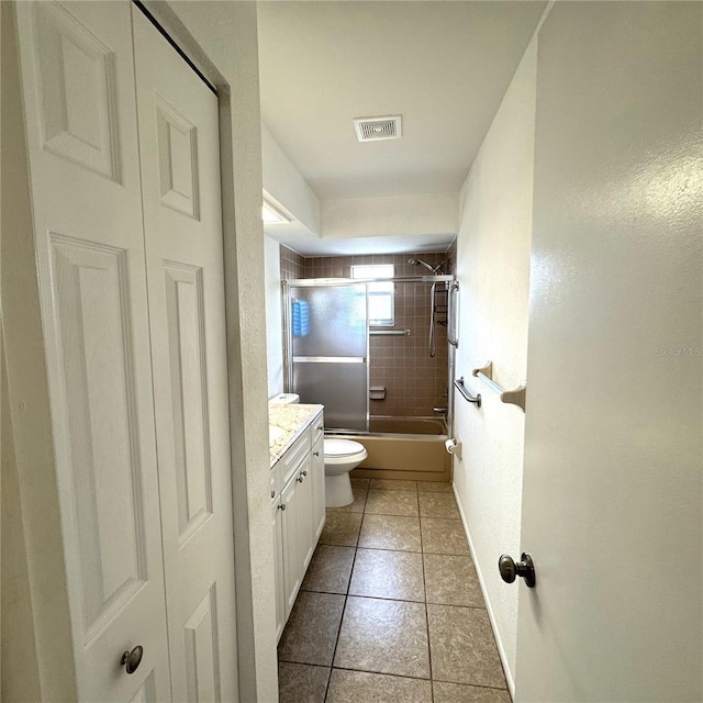 full bathroom with toilet, vanity, shower / bath combination with glass door, and tile patterned flooring