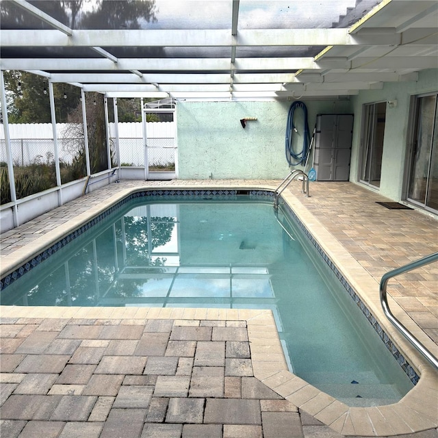 view of pool featuring a patio area and glass enclosure