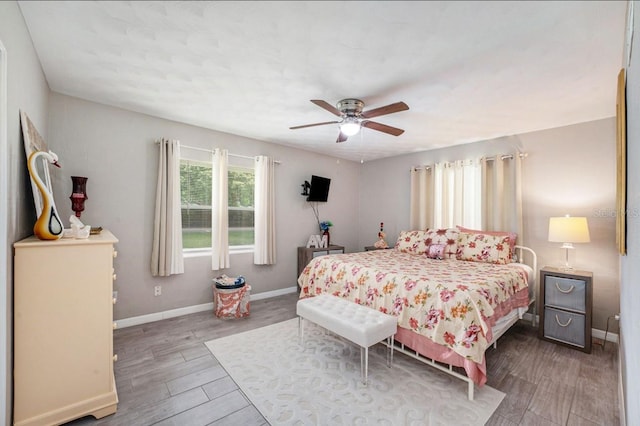 bedroom with hardwood / wood-style flooring and ceiling fan