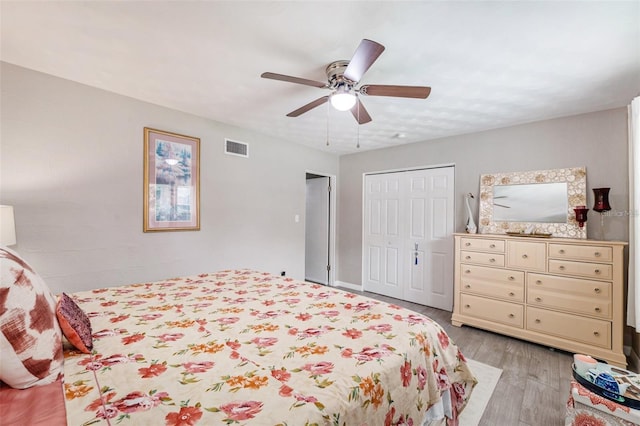 bedroom with a closet, ceiling fan, and light wood-type flooring