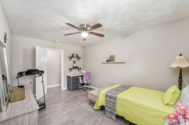 bedroom featuring a textured ceiling, ceiling fan, and light hardwood / wood-style flooring