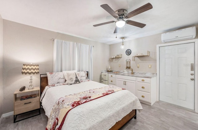 bedroom featuring ceiling fan, a wall unit AC, and light hardwood / wood-style flooring