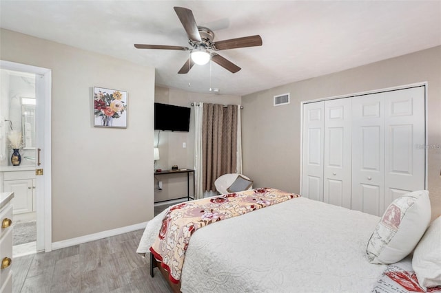 bedroom with ceiling fan, ensuite bathroom, light hardwood / wood-style floors, and a closet