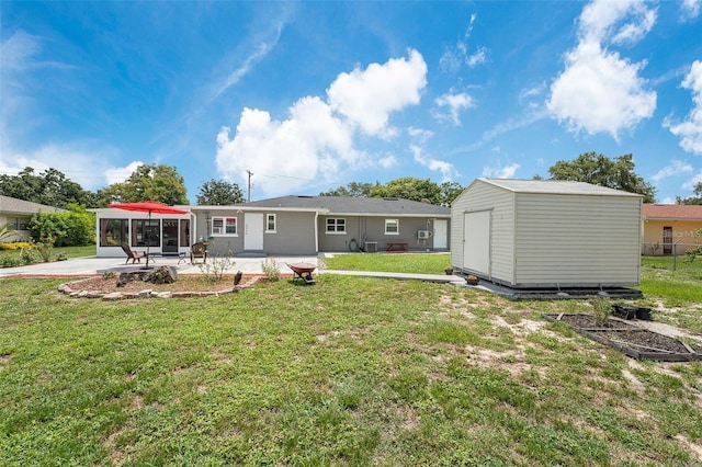 back of property featuring a storage unit, a yard, and a patio area