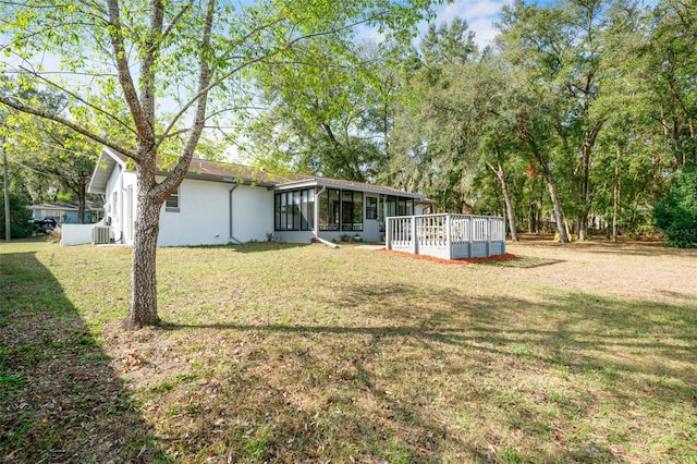 view of yard featuring a sunroom and a deck