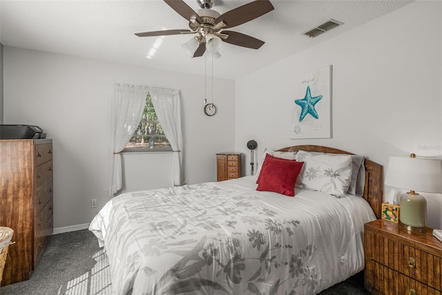 carpeted bedroom with ceiling fan and a textured ceiling