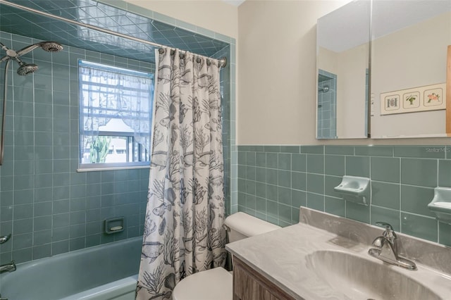 full bathroom with shower / bath combo, tile walls, vanity, and toilet