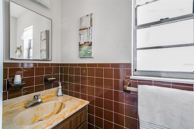 bathroom with vanity and tile walls