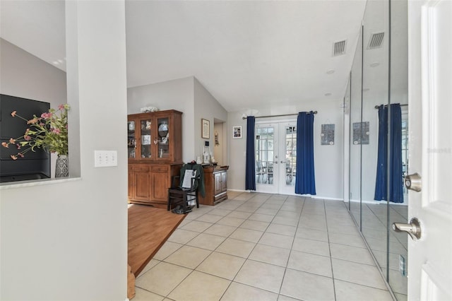 entryway featuring light tile patterned flooring and french doors