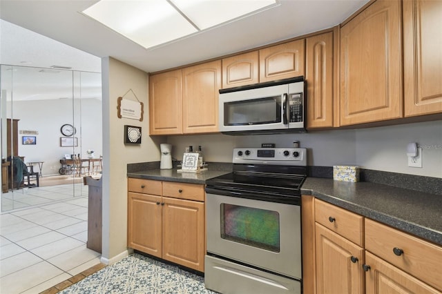 kitchen featuring stainless steel appliances and light tile patterned floors