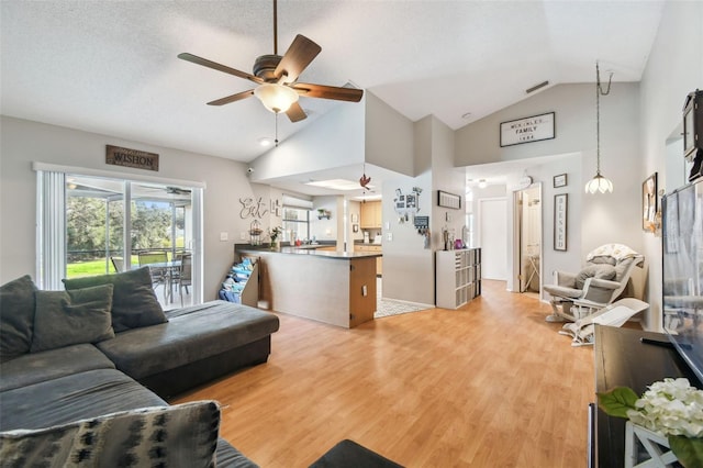 living room featuring ceiling fan, high vaulted ceiling, hardwood / wood-style floors, and a textured ceiling