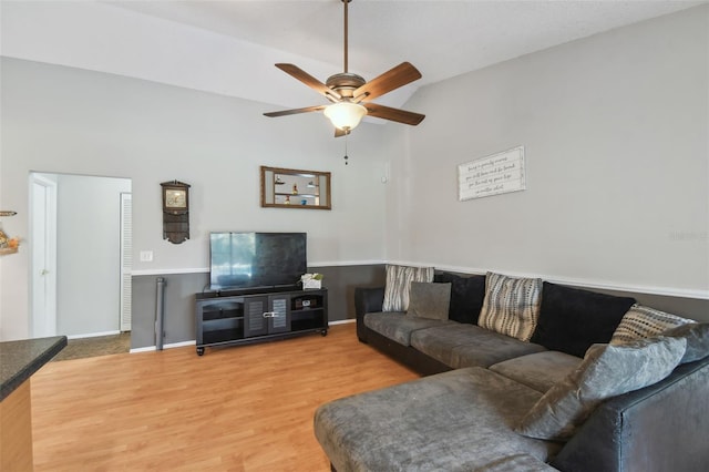 living room with wood-type flooring and ceiling fan