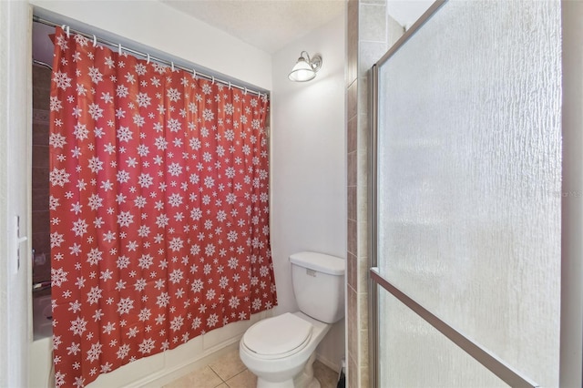 bathroom with a shower, tile patterned floors, and toilet