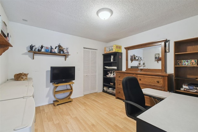 office featuring light hardwood / wood-style flooring and a textured ceiling