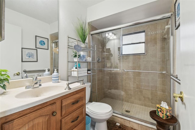 bathroom with vanity, toilet, and an enclosed shower