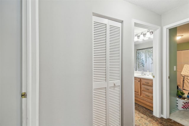 interior space featuring sink and a textured ceiling