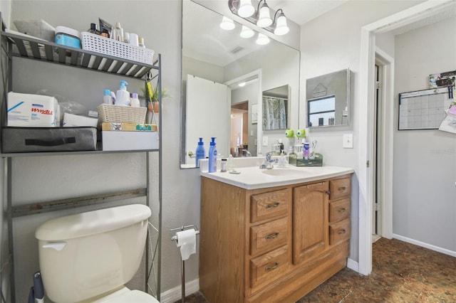 bathroom with vanity and toilet