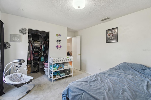 bedroom with carpet floors, a closet, and a textured ceiling