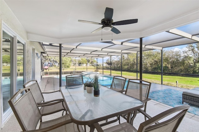 sunroom / solarium with ceiling fan and a pool